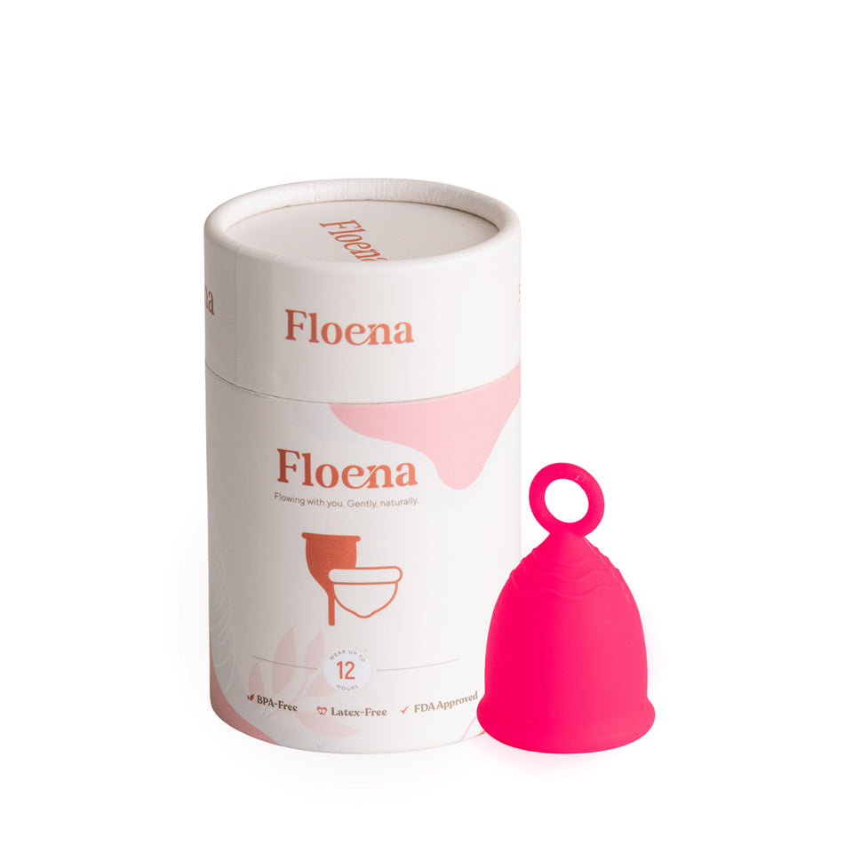 Floena Ring Cup — vibrant pink soft, flexible menstrual cup with a ring handle beside its packaging, up to 12 hours of leakproof protection