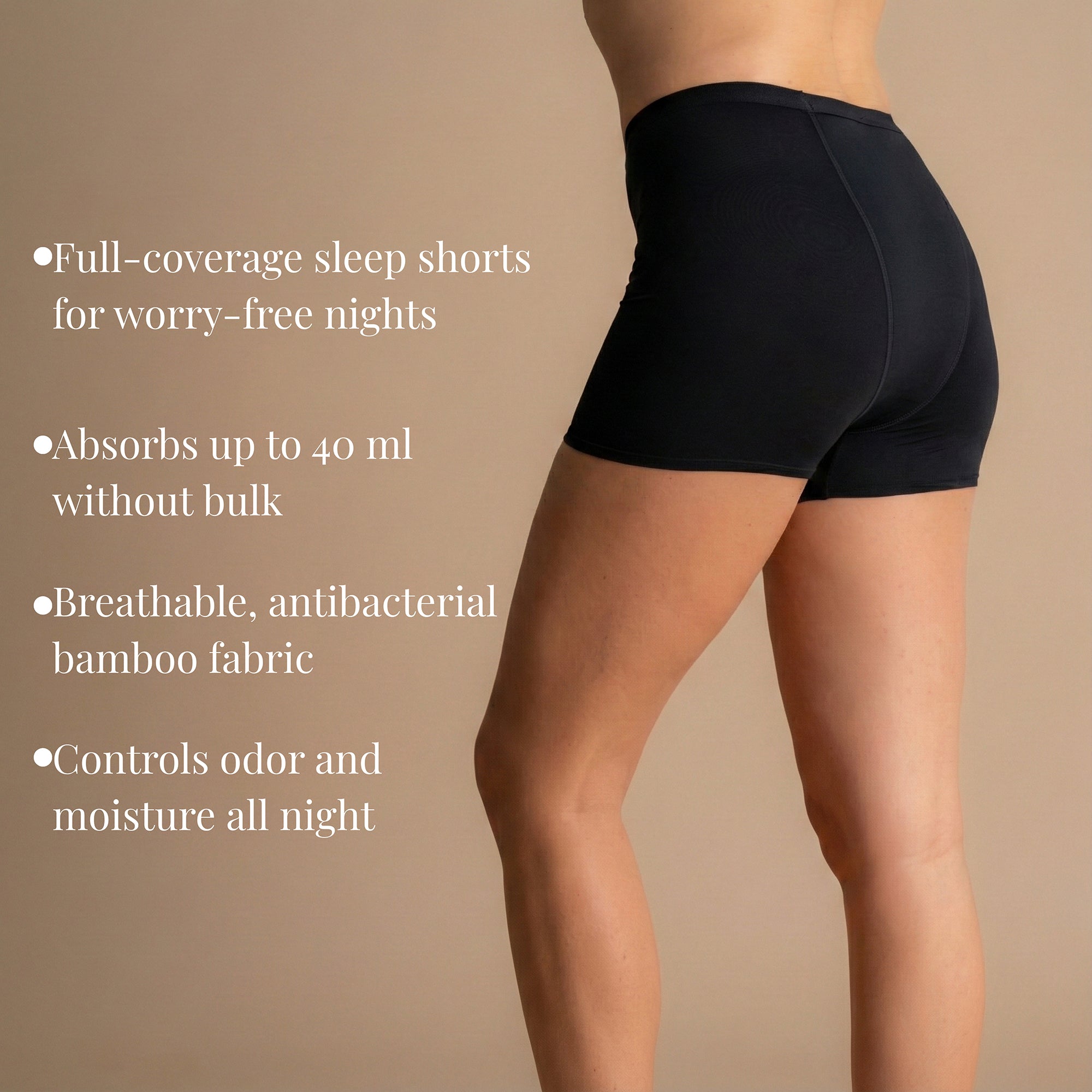 Back view of model wearing black Leakproof Bamboo Sleep Short full-coverage period sleep shorts against beige background