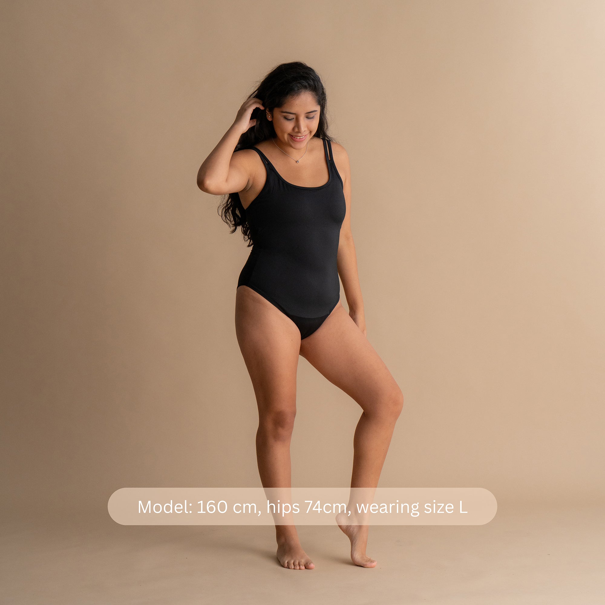 Front Side view of the model wearing the black Leakproof Period One-Piece Swimsuit, demonstrating a comfortable and secure fit with period protection, perfect for confidence and freedom while swimming.