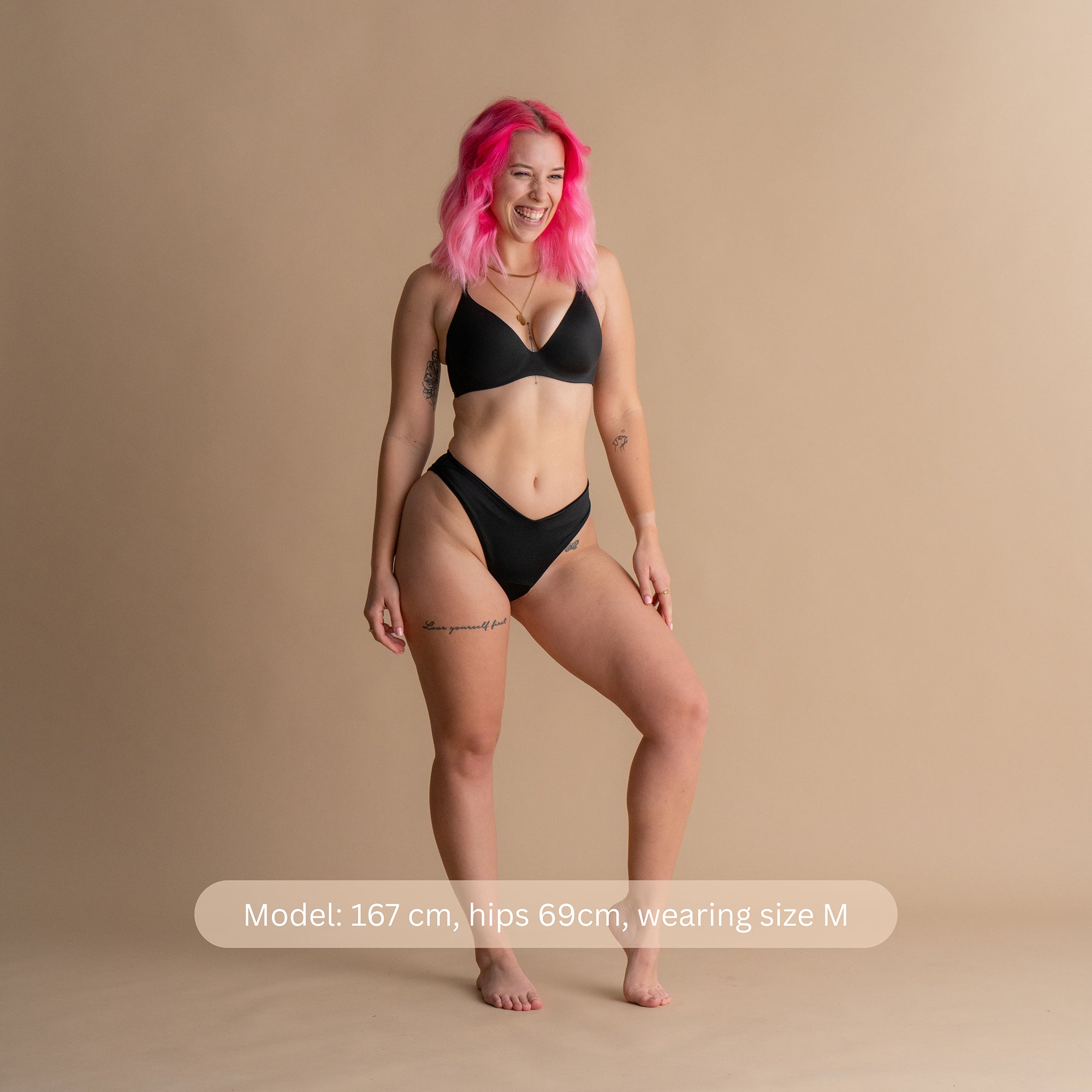 Full Body Front View in Black – The model in this image is wearing a black Leakproof Period Swim Bikini Bottom, featuring discreet, built-in protection for comfort and confidence, offering a flattering high-cut design. The bikini bottom provides a comfortable, feminine fit, ensuring security against leaks while swimming.