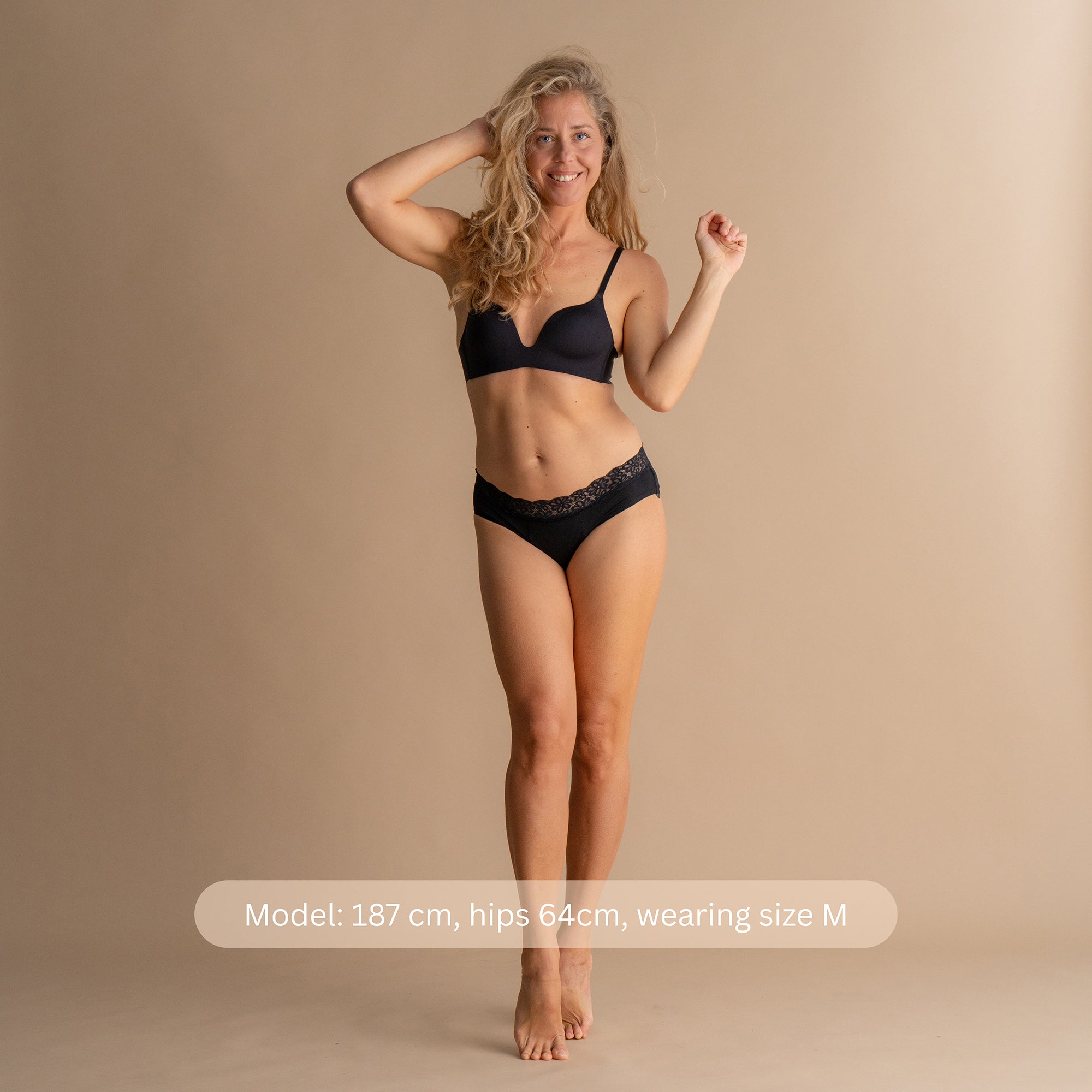 Full body front view of a model wearing the Leakproof Soft Cotton Brief in black, showcasing the soft lace design and comfortable fit. The model is 187 cm tall with hips 64 cm, wearing size M.